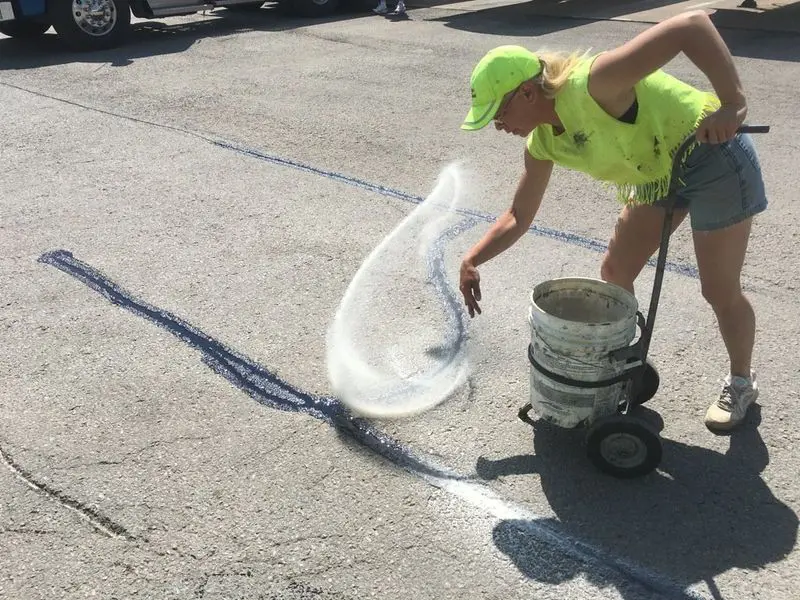 woman sealing cracks